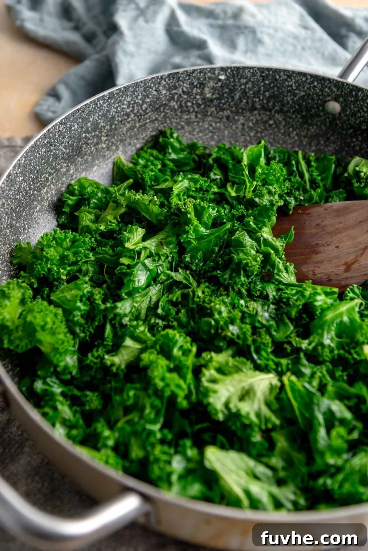 Vegan Lentil Power Bowl 8 Fresh kale leaves steaming in a large skillet, bright green and tender.