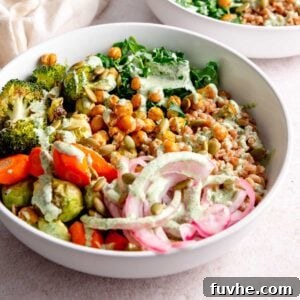 A vibrant and healthy vegan farro bowl, garnished with fresh herbs.