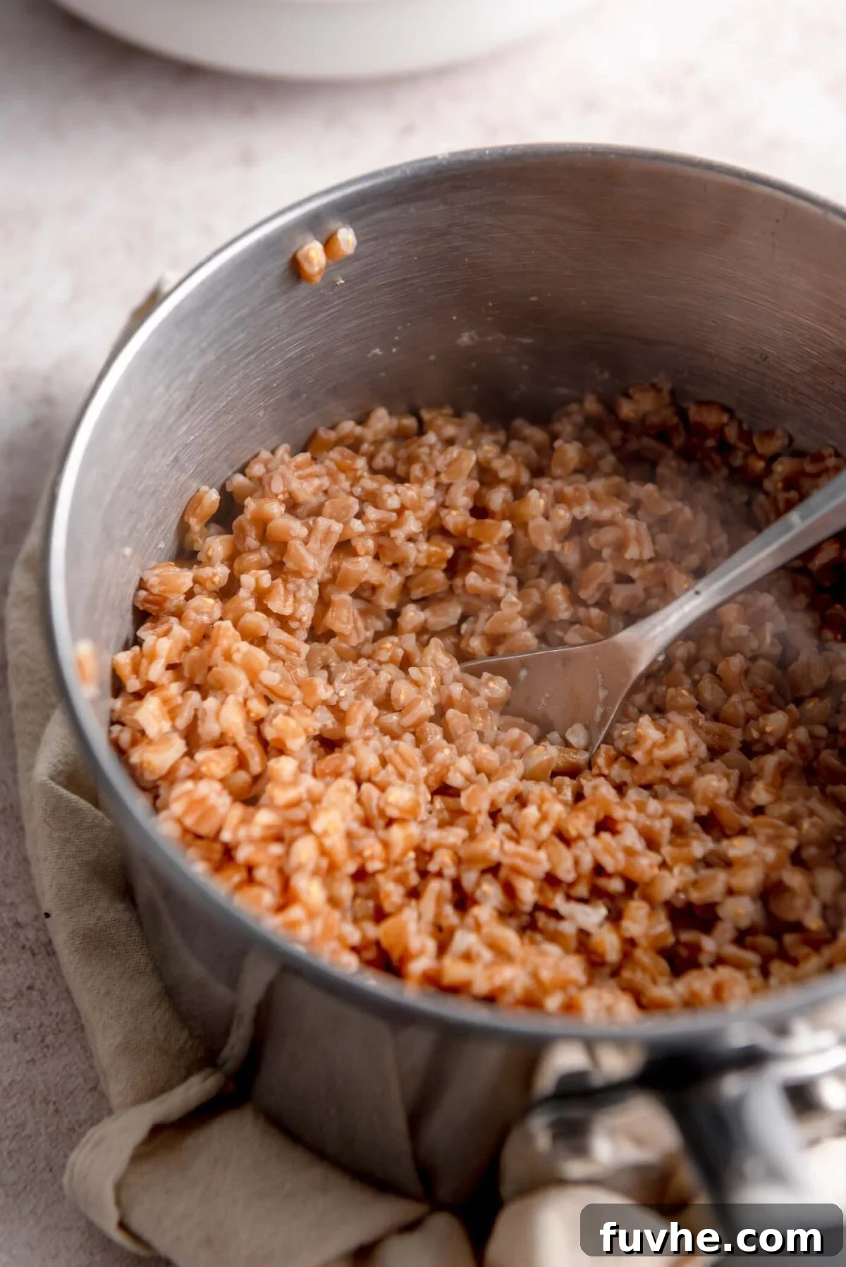 Farro being cooked in a saucepan on the stovetop.