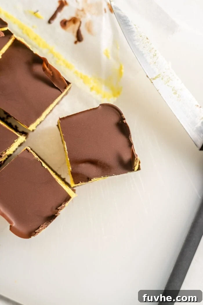 Vegan Nanaimo Bar Delight 12 Sliced Nanaimo Bars on a cutting board.