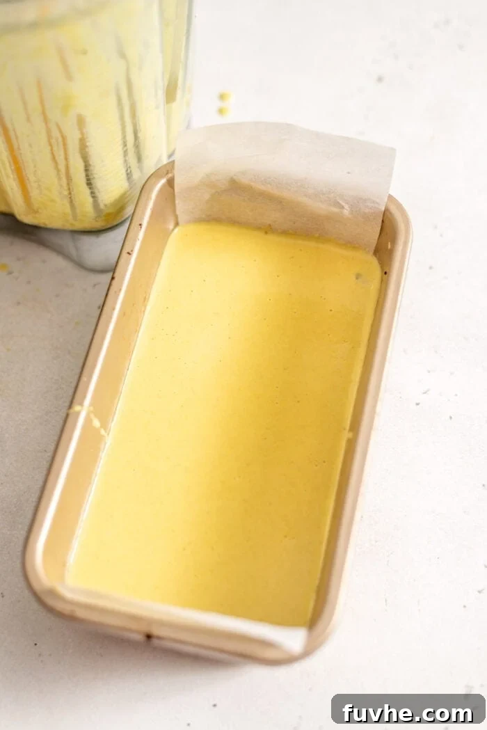 Vegan Nanaimo Bar Delight 8 The custard layer for Nanaimo Bars in a loaf pan lined with parchment paper.