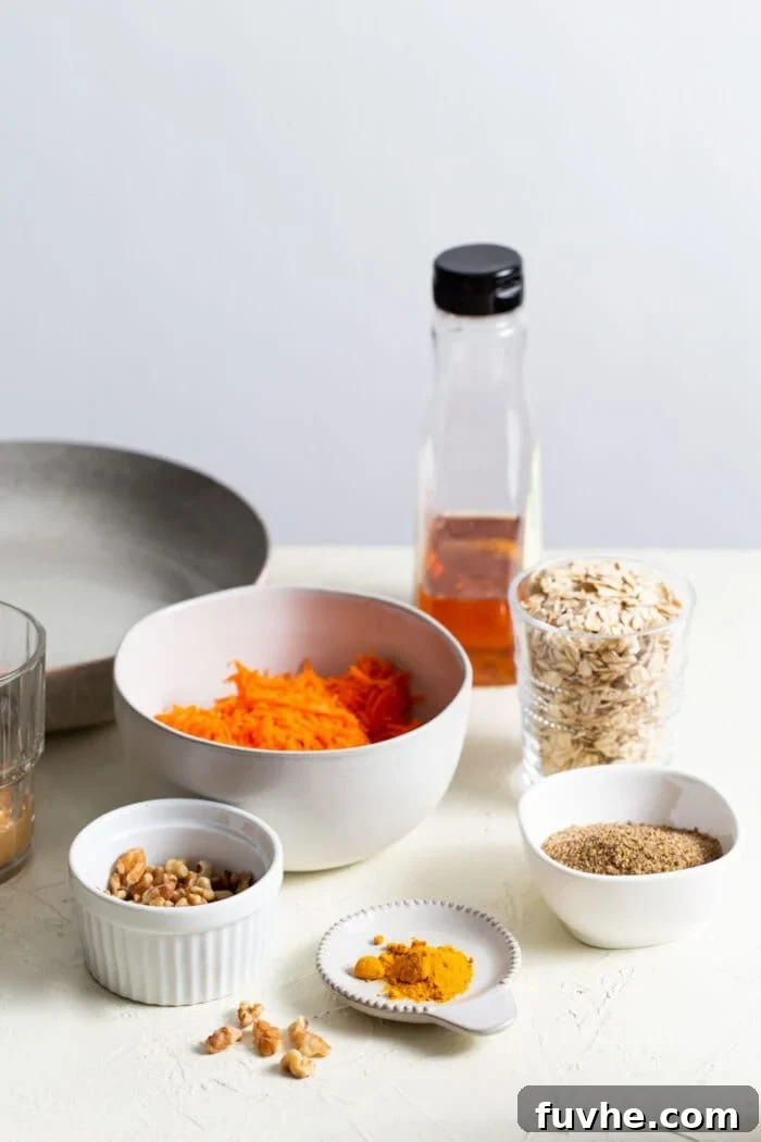 High-Fiber Powerhouses 3 Carrots, walnuts, oats, maple syrup and turmeric in small dishes on a counter top.