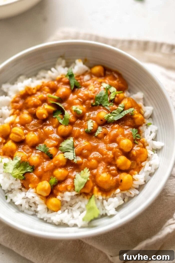 High-Fiber Powerhouses 6 A bowl of chickpea tikka masala over rice topped with cilantro.