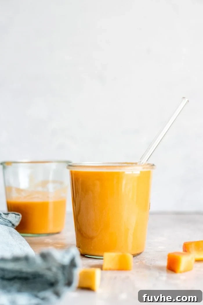 High-Fiber Powerhouses 9 Two glasses filled with creamy vegan papaya smoothies.
