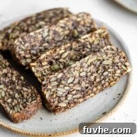 Slices of hearty seed bread on a plate.
