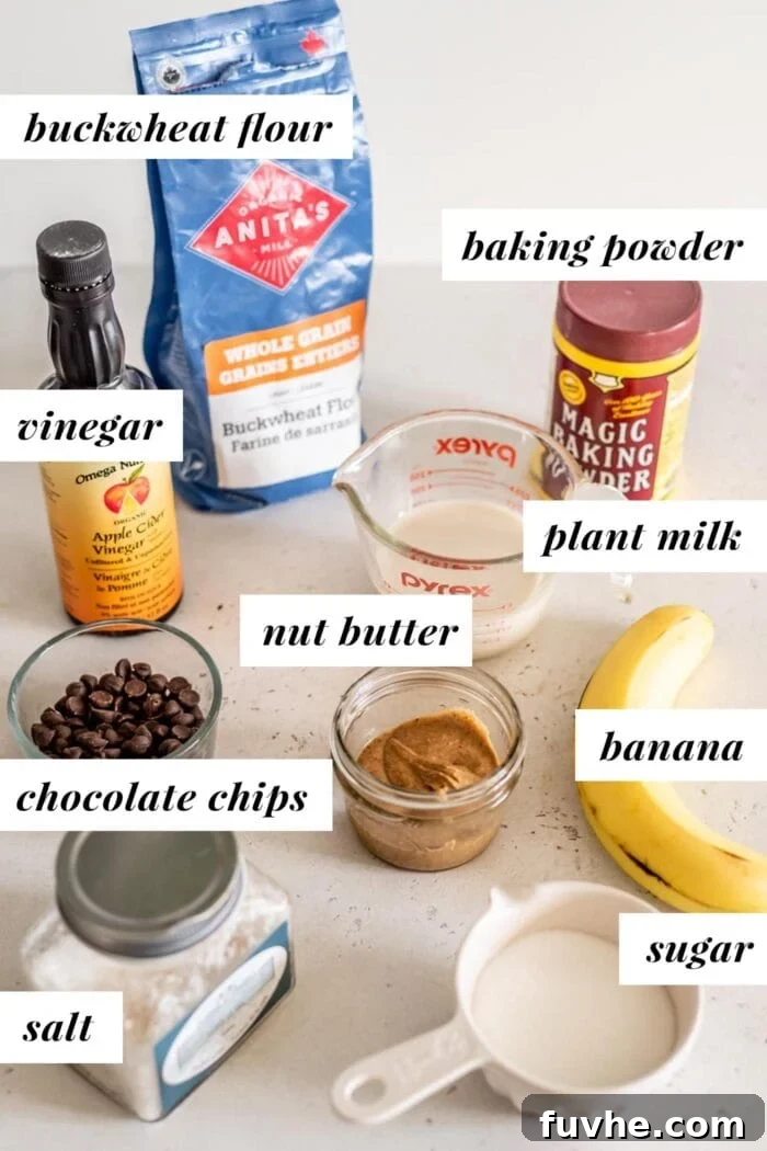 Labelled ingredients for vegan buckwheat muffins, including banana, nut butter, sugar, milk, buckwheat flour, and add-ins.