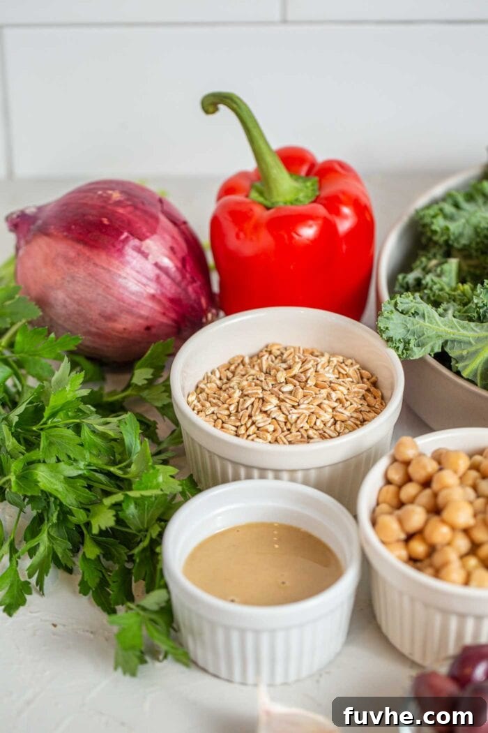 Iron Rich Vegan Foods 2 Farro, chickpeas, tahini, bell peppers and onions in containers on a counter.