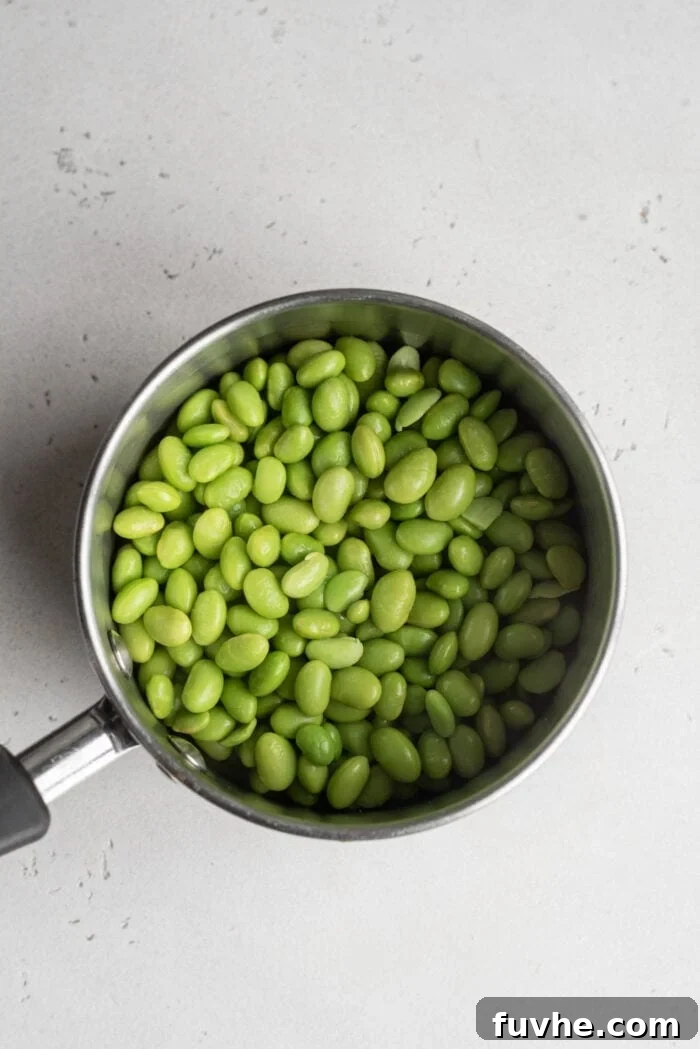 Tropical Mango Edamame Salad 4 Boiled edamame in a pot, demonstrating the first step of preparation.