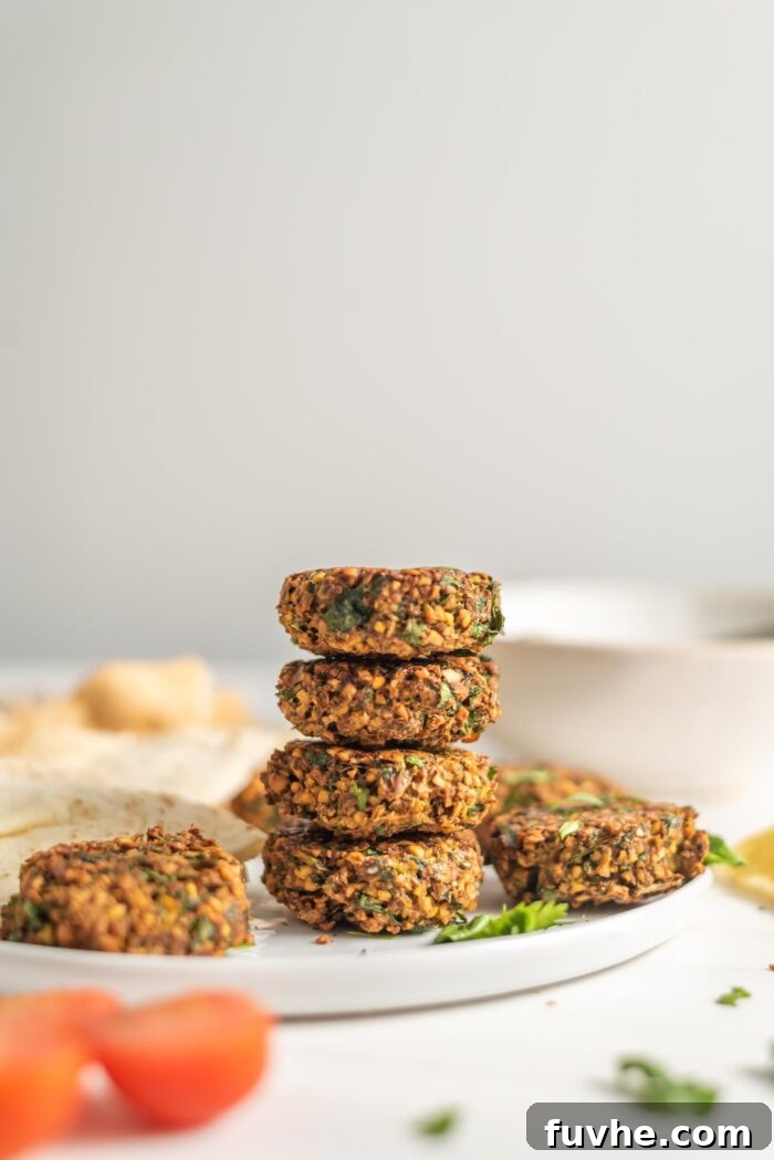 Golden Baked Falafel 14 A perfect stack of golden, crispy baked falafel patties on a white plate, ready to be served.
