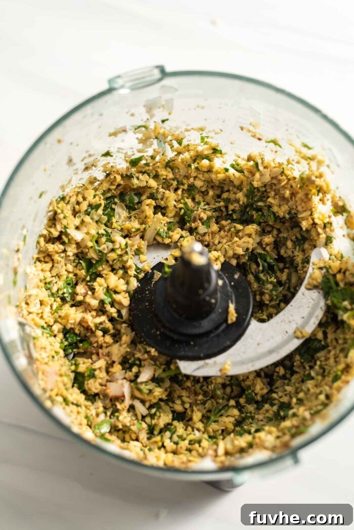 Golden Baked Falafel 7 A vibrant, coarsely blended chickpea and herb mixture in the food processor, ready for the next step.