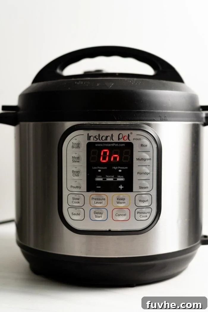 The display panel of an Instant Pot showing "On," indicating that the pressure cooker is currently building pressure to cook the vegetable rice pilaf.