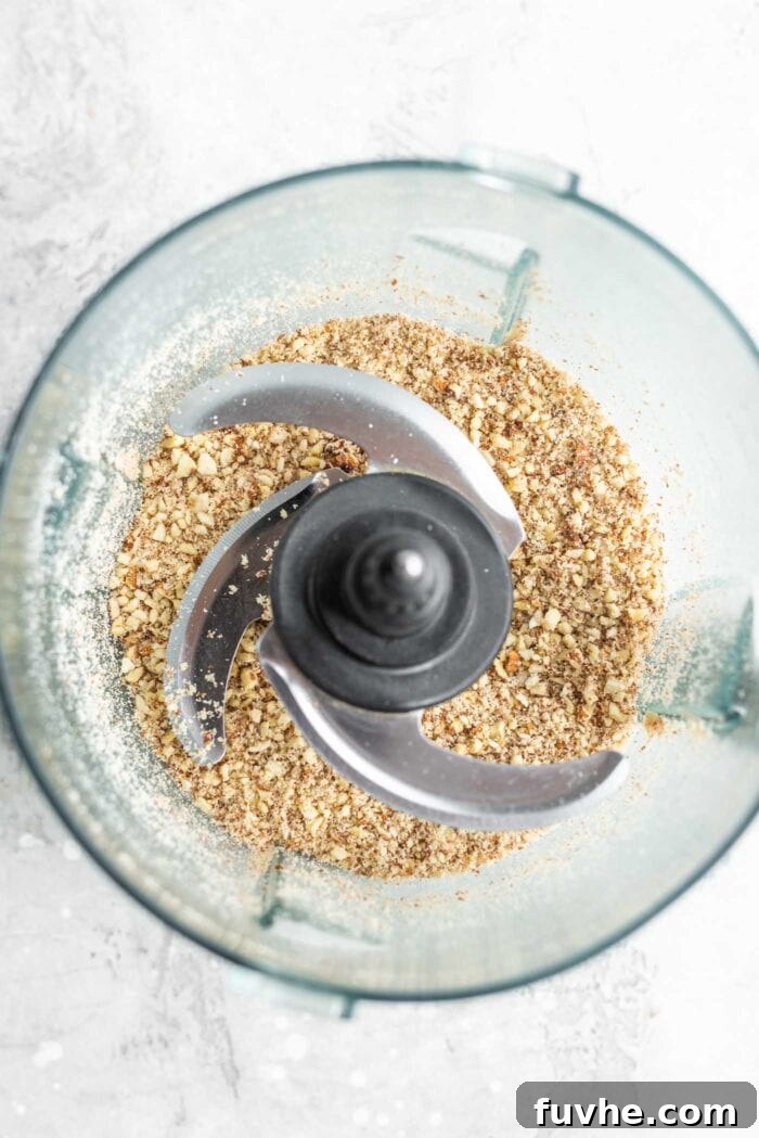Blended oats and almonds in a food processor.