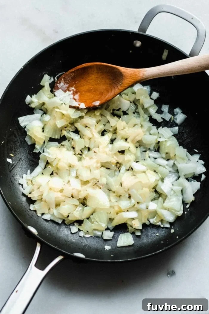 Creamy Vegan Coconut Red Lentil Dahl 4 Diced onions, minced garlic, and grated ginger sizzling in coconut oil in a large skillet, beginning to soften.