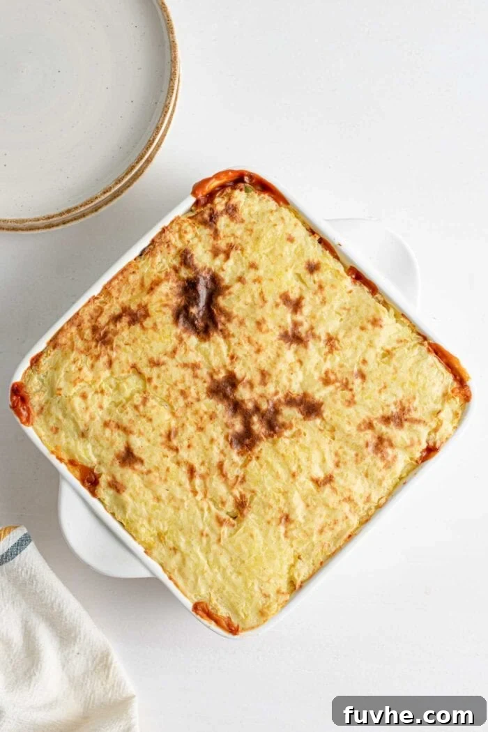 Comforting Vegan Lentil Shepherd's Pie 11 An overhead view of a perfectly assembled lentil shepherd's pie in a baking dish, with the creamy mashed potato topping artfully spread over the savory lentil filling.