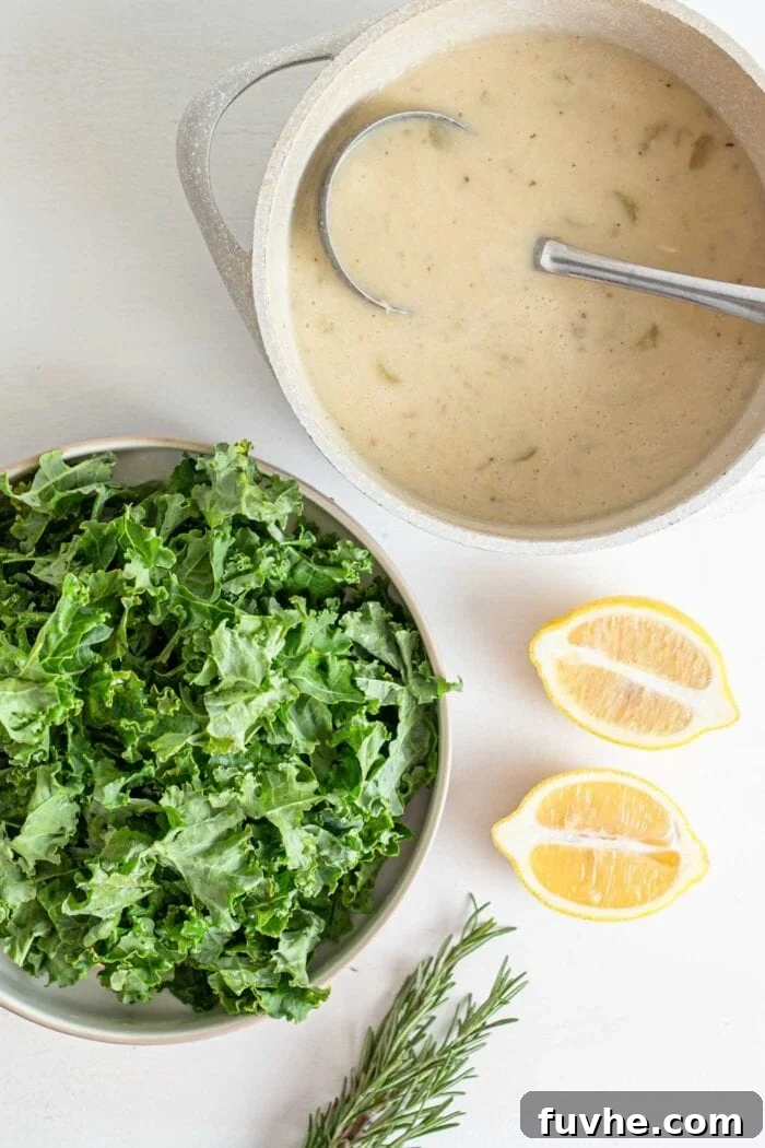 Nourishing Tuscan Kale and White Bean Soup 7 A creamy white bean soup in a large soup pot beside a bowl of kale.