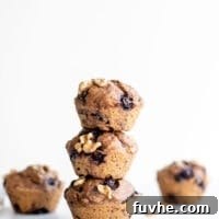 A stack of healthy vegan blueberry muffins sitting on a white surface, ready to be enjoyed.