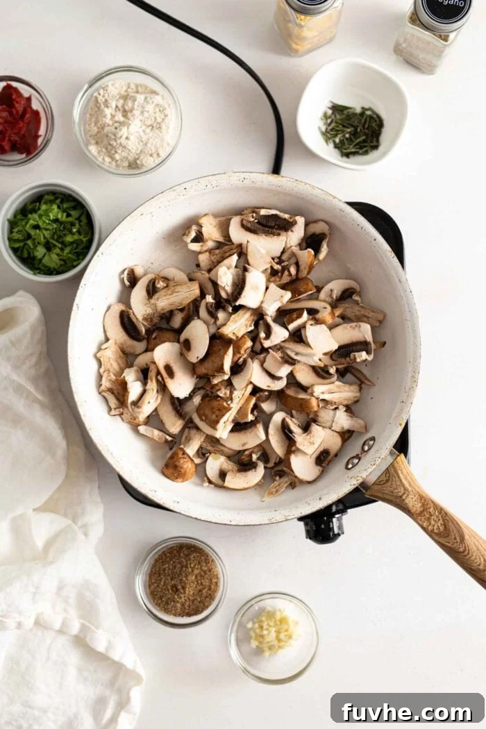 Savory Lentil Plantballs 5 Finely chopped mushrooms sizzling gently in olive oil within a hot skillet on a stovetop, gradually turning golden brown.