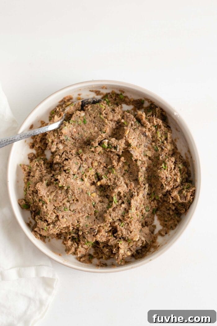 Savory Lentil Plantballs 7 A rich, flavorful ground lentil and mushroom mixture for vegan meatballs resting in a mixing bowl, ready for shaping.