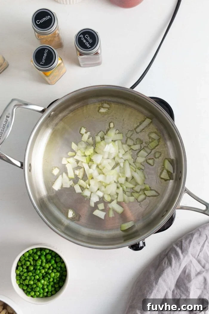 Creamy Vegan Vegetable Korma 5 Finely chopped onions sizzling in a skillet with olive oil over medium-high heat, turning translucent as they cook.