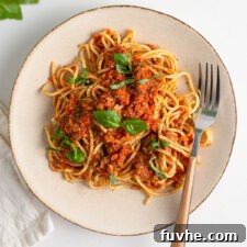 Overhead view of a plate of spaghetti and bolognese sauce.