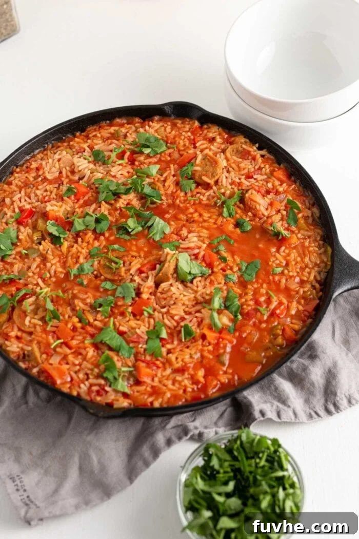 A large pot of vegan jambalaya, garnished with fresh parsley, ready to be served.