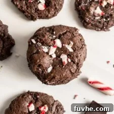 Overhead view of chocolate cookies topped with crushed candy canes.