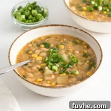 Bowl of vegan white chili topped with fresh sliced scallions.
