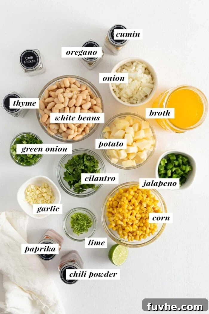 Creamy Vegan White Bean Chili 3 All ingredients needed for making white bean chili, each labelled with text, neatly arranged.