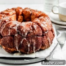 Monkey bread drizzled with icing sugar on a serving tray.
