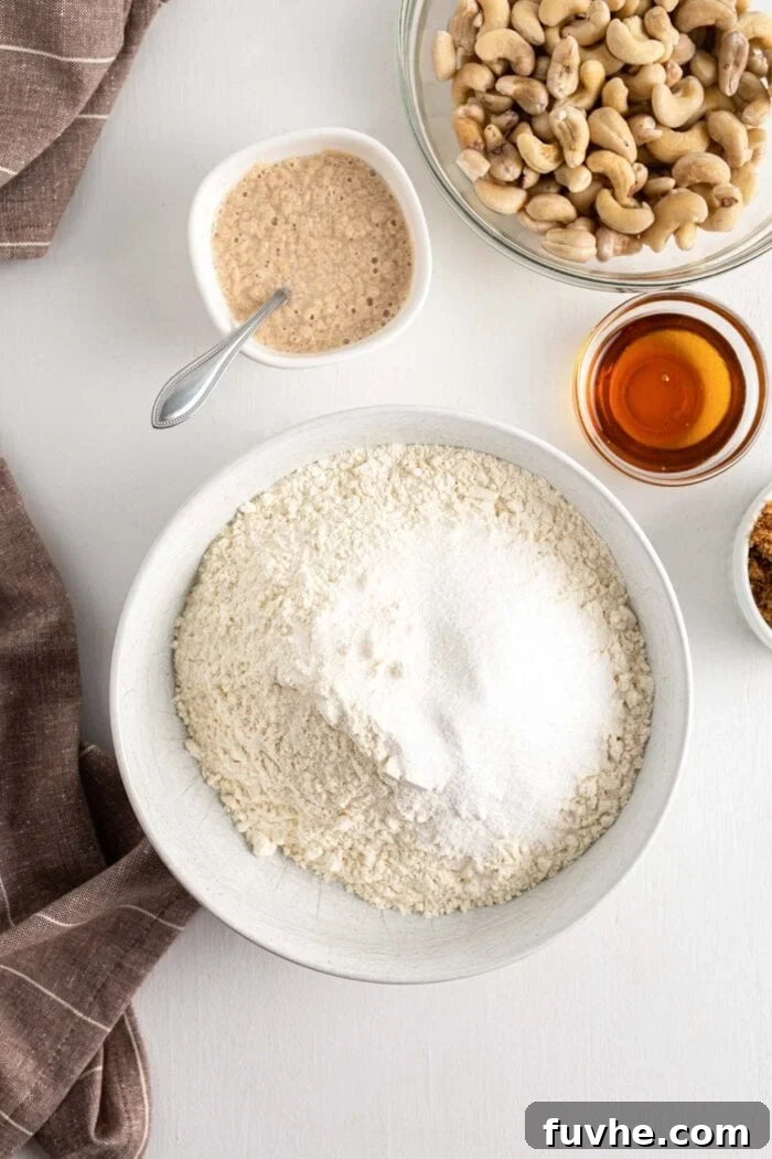A large mixing bowl containing a well-combined mixture of flour and sugar, ready for wet ingredients.