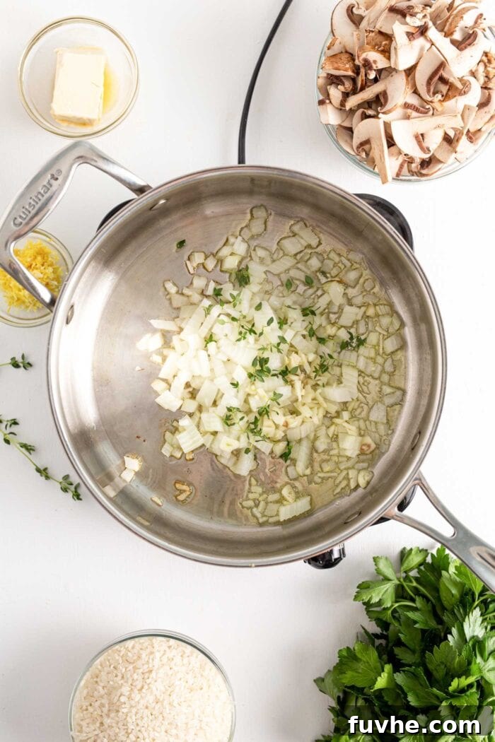 A small cooktop shows a pot with chopped onion, fresh thyme sprigs, and minced garlic gently cooking in olive oil until translucent and fragrant.