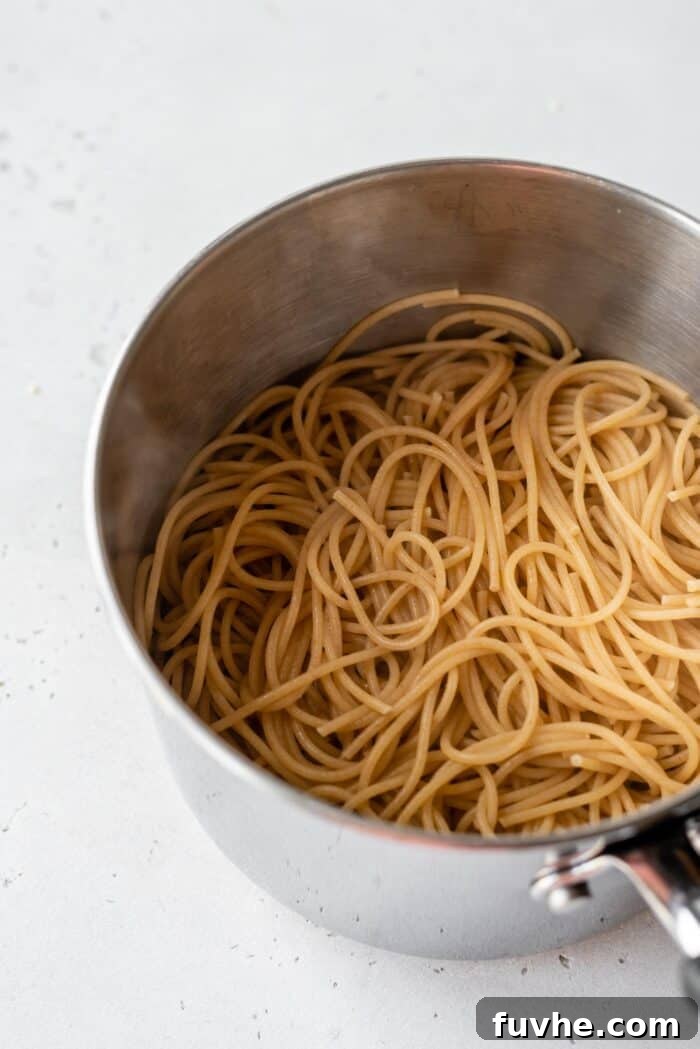 Refreshing Asian Peanut Noodles 4 Cooked spaghetti noodles in a pot.