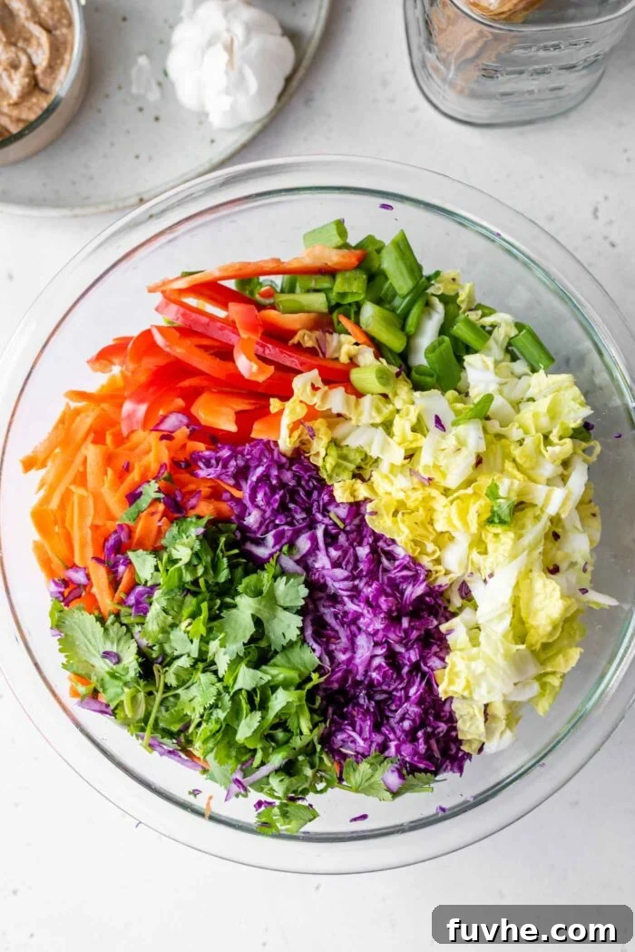 Refreshing Asian Peanut Noodles 5 Chopped scallions, cabbage, carrot and cilantro in a large mixing bowl.