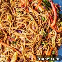 Refreshing Asian Peanut Noodles 9 A peanut noodle salad with chopped vegetables in a large mixing bowl.