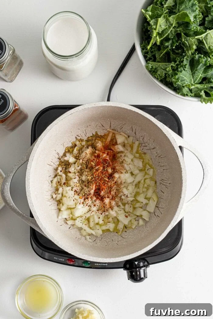 Creamy Plant Based Zuppa Toscana 4 Diced onions and aromatic spices gently cooking in olive oil within a large soup pot, releasing their fragrant essence.