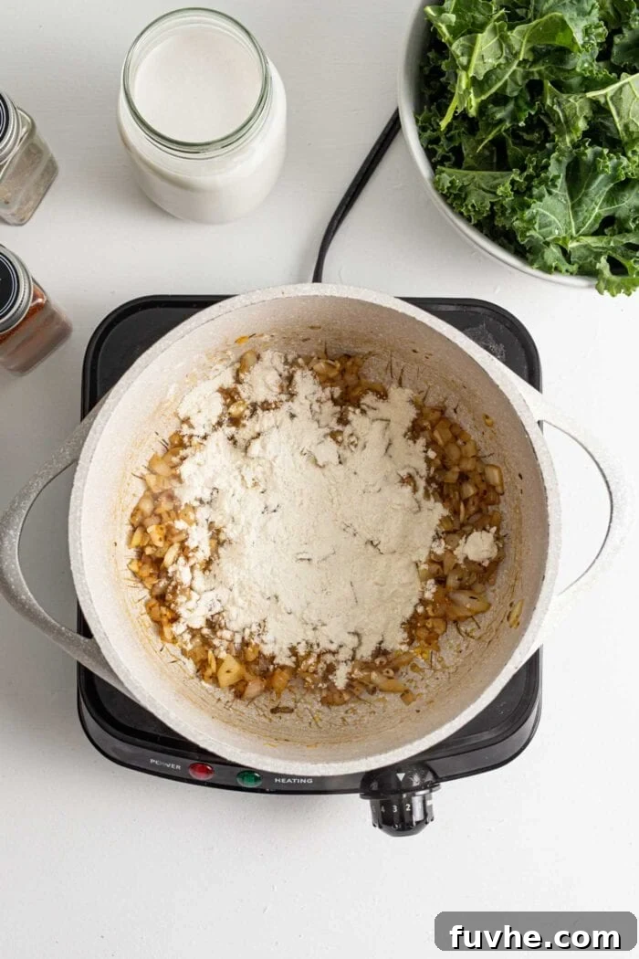 Creamy Plant Based Zuppa Toscana 6 All-purpose flour lightly dusted over the sautéed onions and spices in a pot, ready to create a thickening roux.
