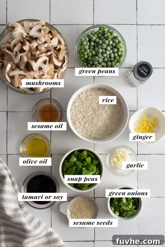 An organized display of all the fresh ingredients required to prepare the vegan mushroom fried rice, clearly labeled for easy identification.