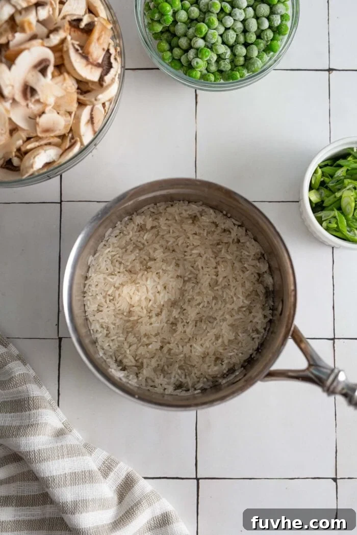 Freshly cooked basmati rice steaming gently in a small, medium-sized pot.