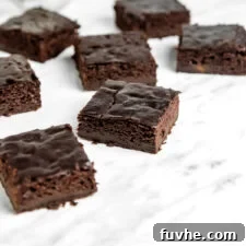 A number of sliced chocolate brownies sitting on a marble surface.