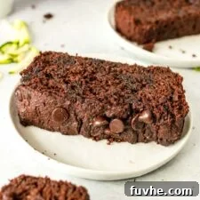 Thick slice of chocolate chip zucchini bread on a plate.