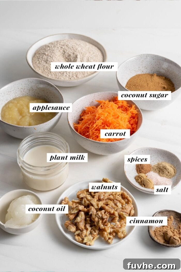 A visual spread of fresh, healthy ingredients laid out for making carrot cake muffins, with each component clearly labeled to assist bakers.