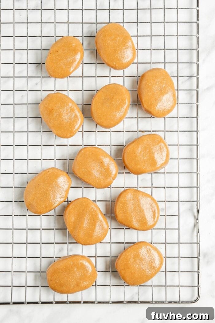 12 peanut butter eggs on a cookie cooling rack