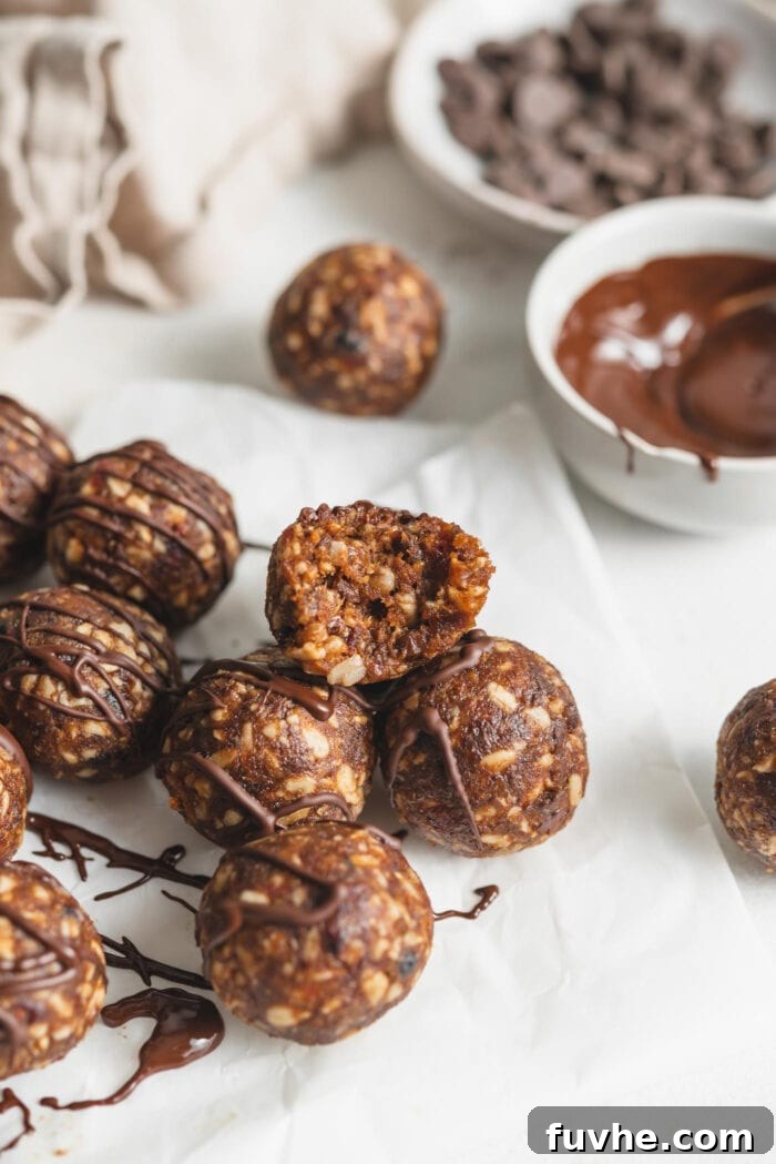 No-bake energy ball with a bite taken out of it to show the inside texture. Reveals the chewy, wholesome interior of the snack.