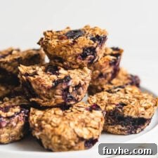 A beautifully presented stack of baked oatmeal cups with blueberries, ready to be enjoyed.