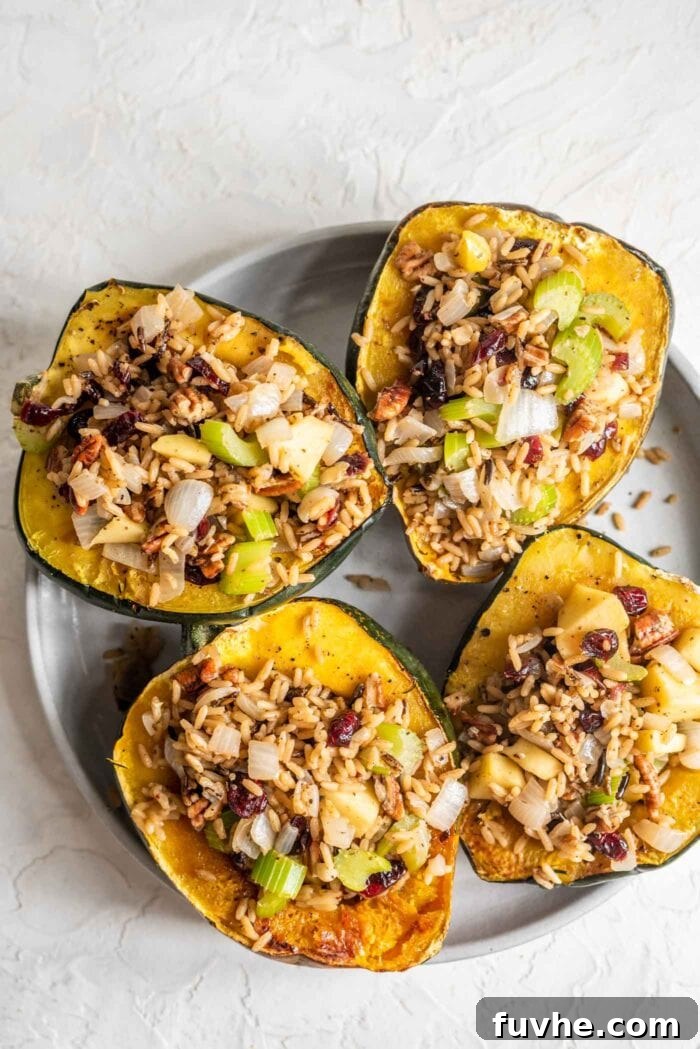 Golden Acorn Feast 2 4 vegan stuffed acorn squash on a grey plate, showcasing the rich colors and textures of the filling.