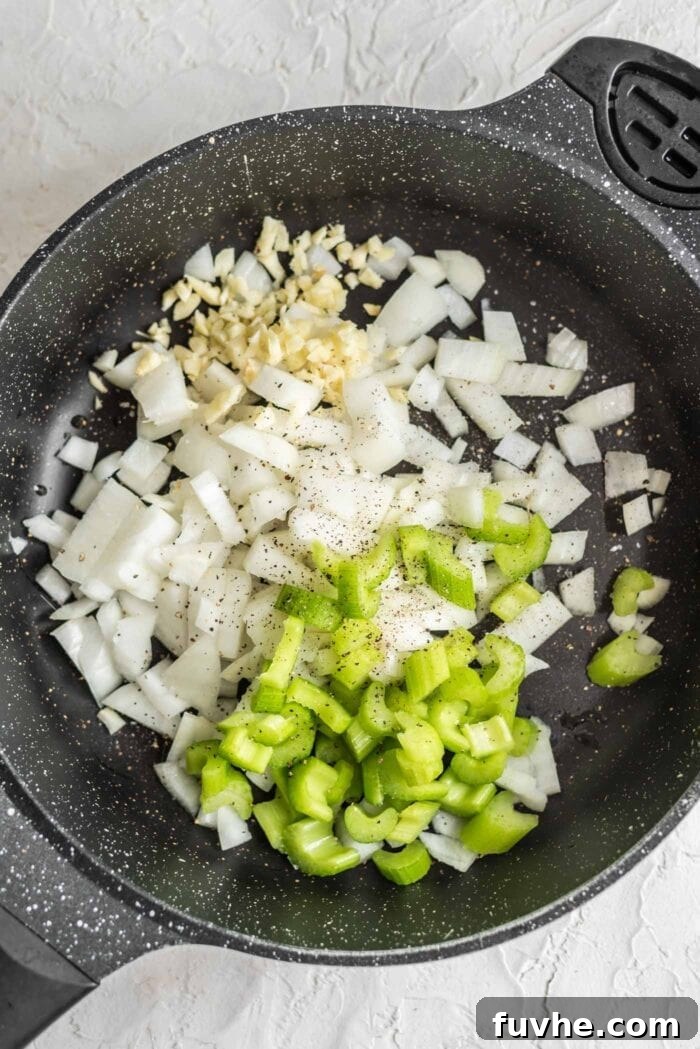 Golden Acorn Feast 6 Celery, onion, garlic, salt and pepper in a black skillet, beginning to sauté.