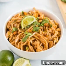 A perfectly portioned bowl of vegan tofu Pad Thai, garnished with fresh herbs and a lime slice, ready to be enjoyed.