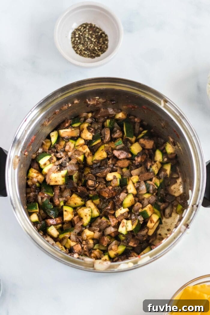 Diced mushrooms and zucchini added to the pot with the sautéed onions and garlic, cooking to tender perfection.