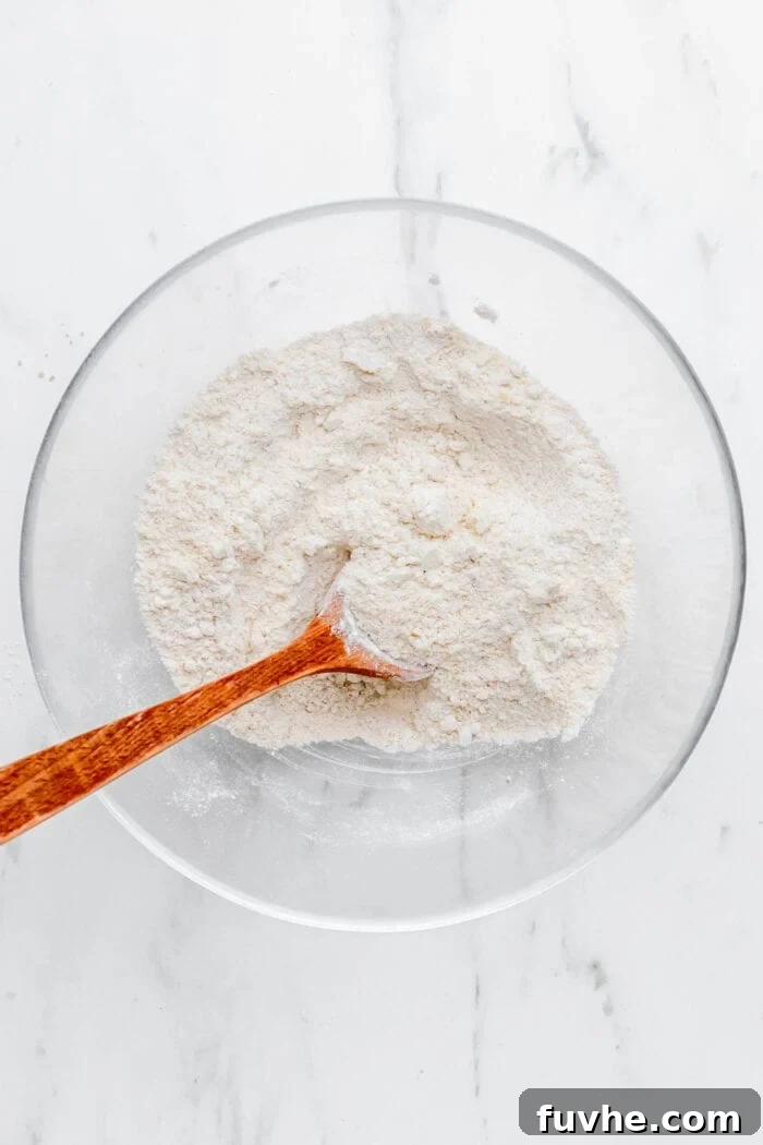 A bowl containing a mix of oat flour and almond flour, ready for the next step in the crumble bar recipe.