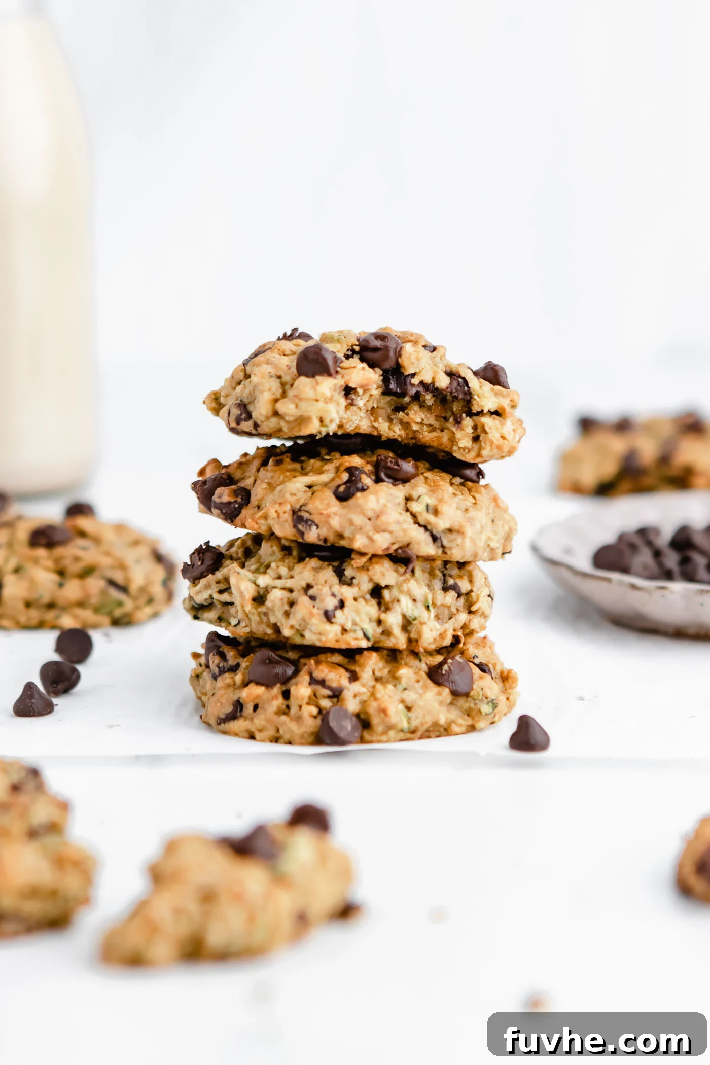 Stack of 4 chocolate chip zucchini cookies. One on the top has a bite out of it.